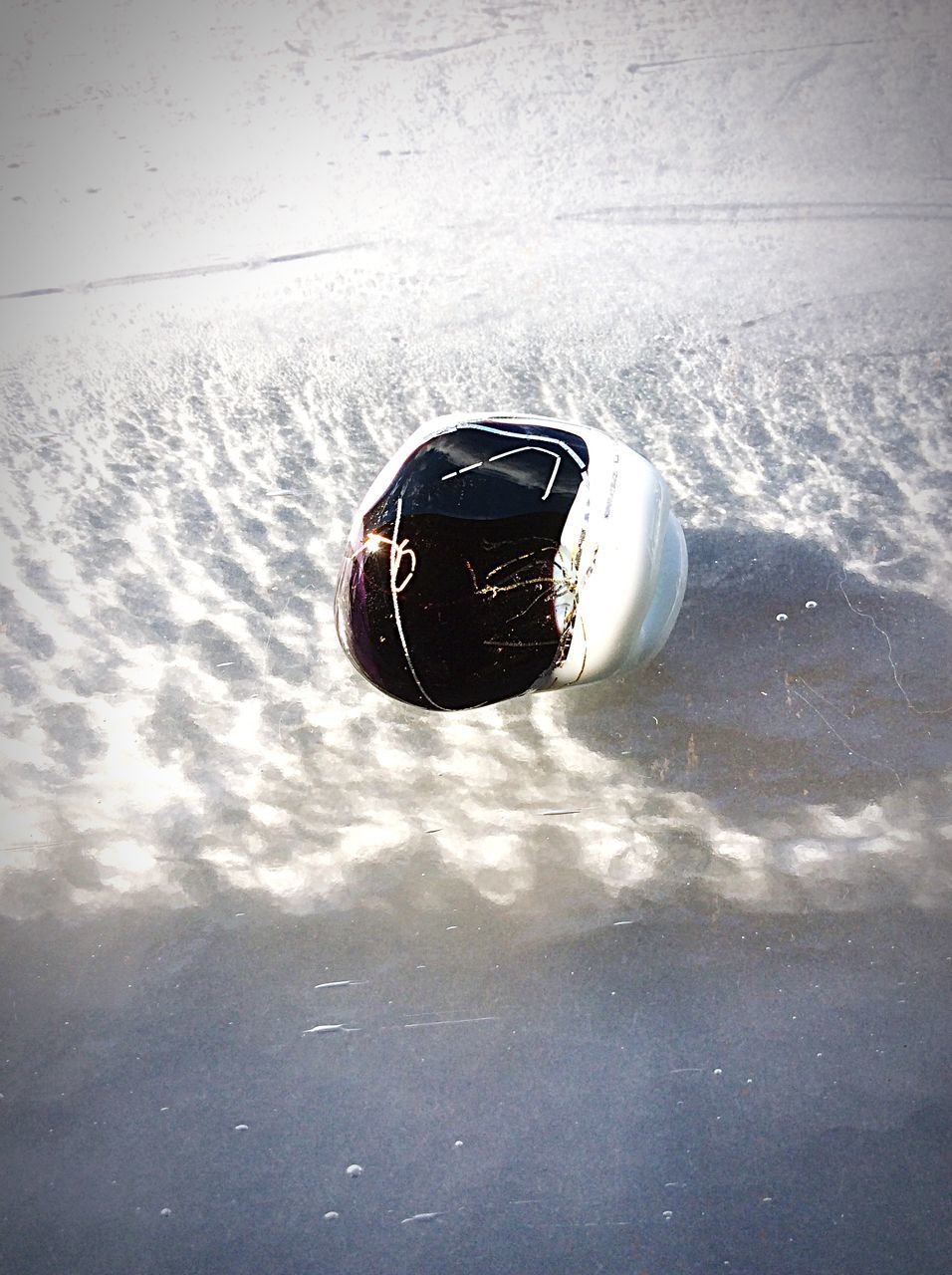 high angle view, water, reflection, close-up, black color, day, nature, no people, outdoors, lake, waterfront, wet, snow, single object, winter, cold temperature, one animal, beauty in nature, floating on water, adventure