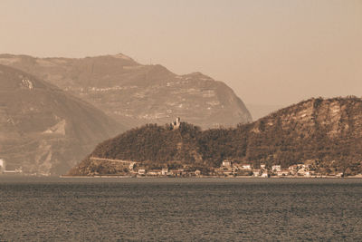 Scenic view of sea and mountains against sky