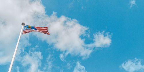 Low angle view of flag against sky