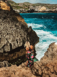 High angle view of woman looking at sea