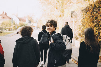 Rear view of people walking outdoors