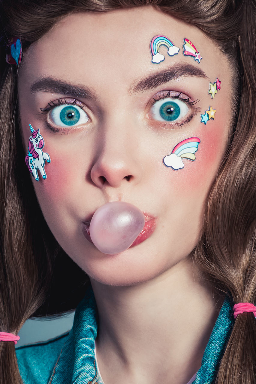 portrait, human face, blue, women, one person, human eye, headshot, make-up, looking at camera, human head, adult, young adult, fashion, nose, close-up, skin, lipstick, hairstyle, eye, lip, brown hair, studio shot, human hair, blue eyes, front view, female, multi colored, long hair, eyelash, indoors, body piercing, jewelry, human mouth, child, arts culture and entertainment, human lips, person, glamour, eye shadow, purple, pink, brown eyes