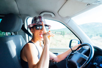 Woman driving in camper van. portrait - stock photo