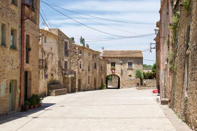 Street amidst buildings against sky