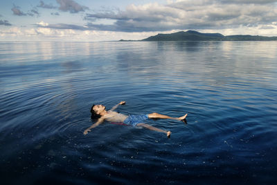 A man floating on water at karimunjawa island, jepara, central java, indonesia