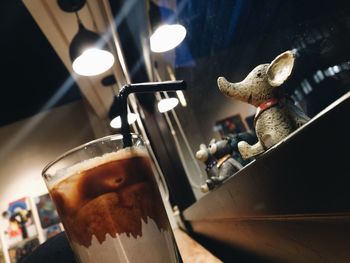 Close-up of cold coffee by animal figurines