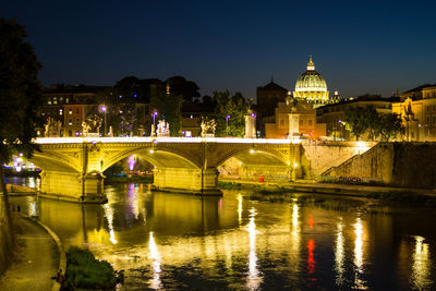 View of bridge over river at night