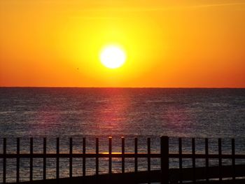 Scenic view of sea against orange sky