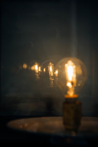 Close-up of light bulb at night