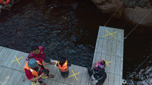 High angle view of people sitting on barbecue grill