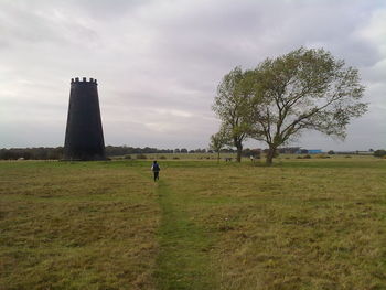 Man standing on field against sky