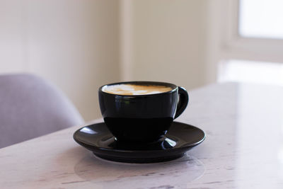 Close-up of coffee cup on table