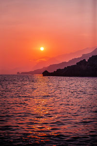 Scenic view of sea against romantic sky at sunset