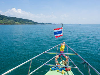 Ferry boat with thailand flag sailing on sea from krabi to ko jum and ko lanta, thailand