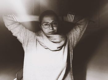 Portrait of young man standing against wall