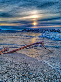 Scenic view of beach against sky during sunset