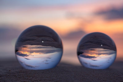 Close-up of glass of water on beach