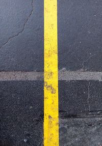 High angle view of yellow sign on road