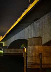 Low angle view of bridge against sky at night