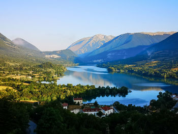 Scenic view of lake and mountains against sky