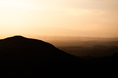 Scenic view of silhouette mountains against sky during sunset