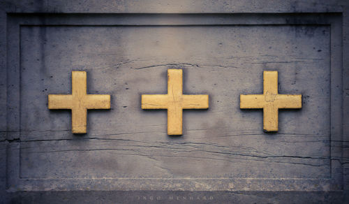 Close-up of crosses on wall