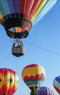 Low angle view of hot air balloon against clear blue sky