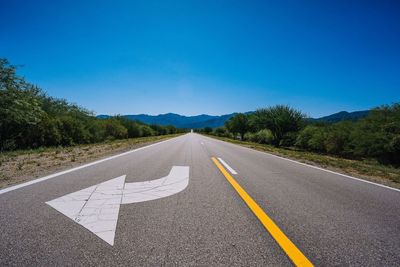 Empty road against blue sky