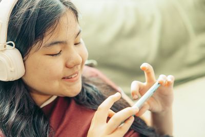 Close-up of young woman using mobile phone