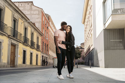 Couple standing on road in city