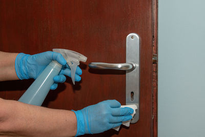 Close-up of human hand on door