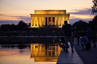 People visiting jefferson memorial at dusk