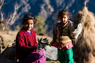 Portrait of smiling girl standing outdoors