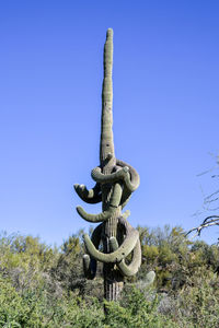 Low angle view of metallic structure against clear blue sky