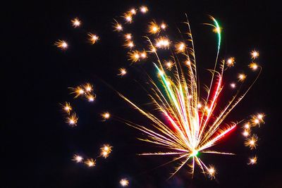 Low angle view of firework display at night