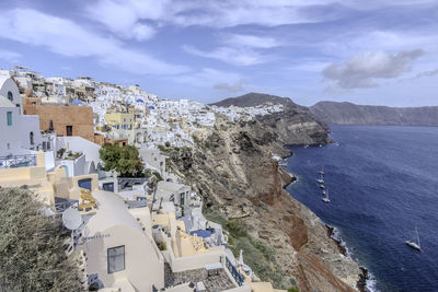 High angle view of townscape by sea against sky