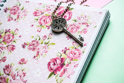 Close-up of pink book and keys on table