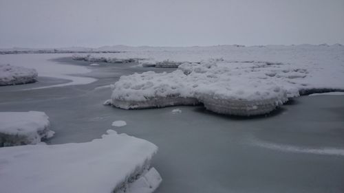 Frozen landscape against sky