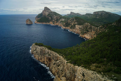 Scenic view of sea and mountains against sky