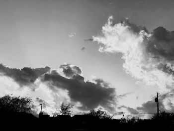 Low angle view of silhouette trees against sky