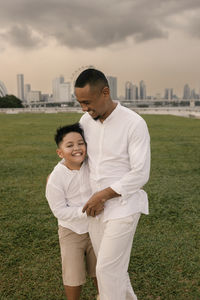 Side view of couple standing on field