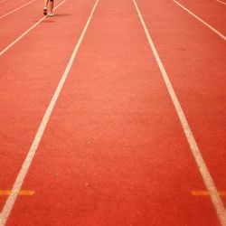 Low section of person on running track