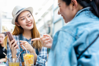 Portrait of happy young woman holding ice cream