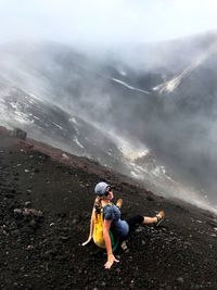 Full length of woman standing on mountain against sky