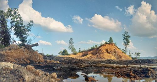 Panoramic view of trees and rocks against sky