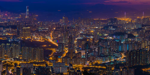 Aerial view of city lit up at night