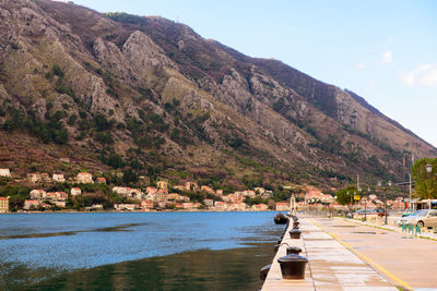 Scenic view of river by mountains against sky