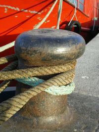 Close-up of rope tied on boat moored at harbor