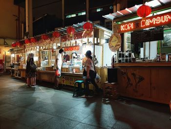 People on illuminated restaurant at night