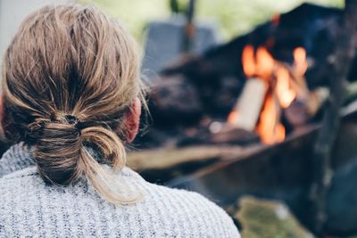 Rear view of a long haired man with fire